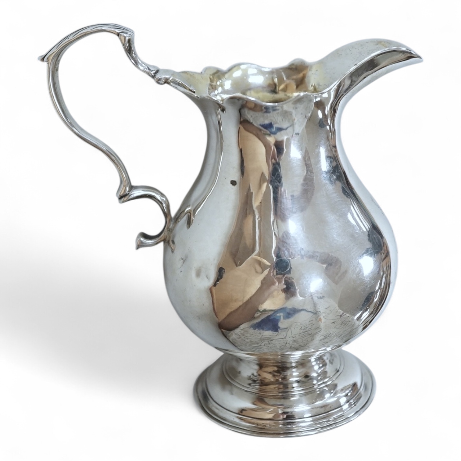 A George II silver baluster cream jug, George Greenhill Jones, London, 1743, height 96mm.